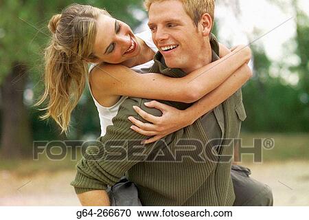 Man giving woman piggyback View Large Photo Image Stock Image - Man giving woman piggyback. Fotosearch