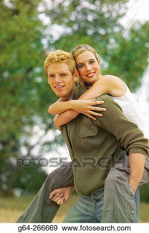 Man giving woman piggyback View Large Photo Image Stock Photo - Man giving woman piggyback. Fotosearch