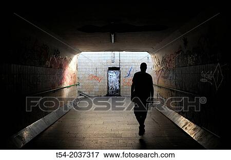 Man goes through a tunnel into the light View Large Photo Image Stock Photo - Man goes through a tunnel into the light. Fotosearch