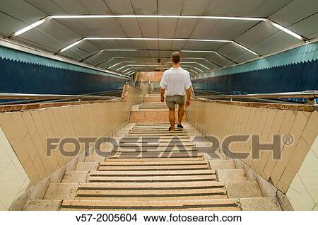 Man going downstairs, underground, Madrid, Spain. View Large Photo Image Picture - Man going downstairs, underground, Madrid, Spain.. Fotosearch