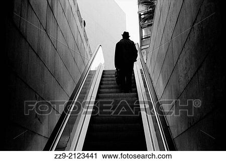 Man going up escalators from a subway. Colon subway station, Valencia, Spain View Large Photo Image Stock Image - Man going up escalators from a subway. Colon subway station, Valencia, Spain. Fotosearch