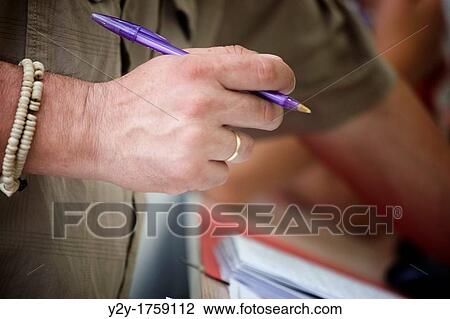 Man hand with pen and bracelet View Large Photo Image Stock Image - Man hand with pen and bracelet. Fotosearch