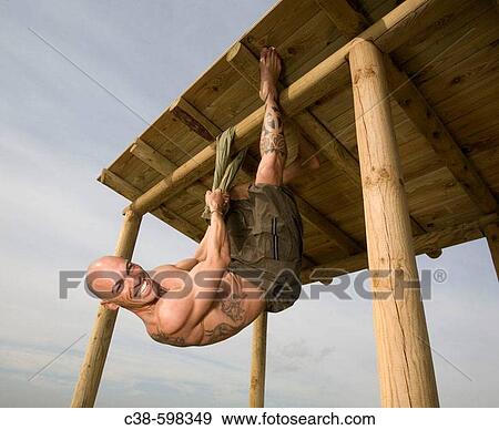 Man Hanging From Wooden Structure View Large Photo Image Stock Photo - Man Hanging From Wooden Structure. Fotosearch