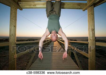 Man Hanging Up Side Down on Footbridge View Large Photo Image Stock Photograph - Man Hanging Up Side Down on Footbridge. Fotosearch