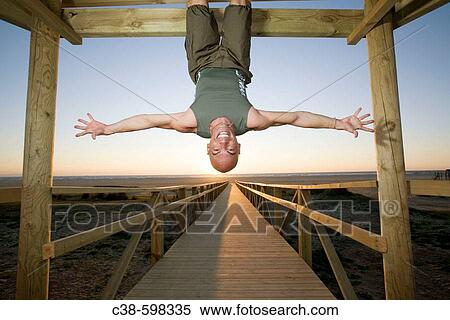 Man Hanging Up Side Down on Footbridge View Large Photo Image Stock Photography - Man Hanging Up Side Down on Footbridge. Fotosearch