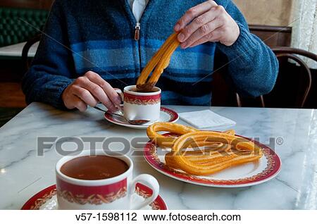 Man having chocolate with churros. Close view. View Large Photo Image Stock Image - Man having chocolate with churros. Close view.. Fotosearch