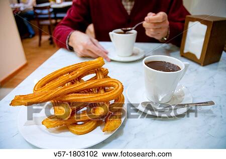 Man having chocolate with churros. Close view. View Large Photo Image Stock Image - Man having chocolate with churros. Close view.. Fotosearch