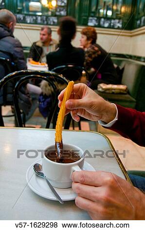 Man having chocolate with churros. Chocolateria San Gines, Madrid, Spain. View Large Photo Image Stock Photo - Man having chocolate with churros. Chocolateria San Gines, Madrid, Spain.. Fotosearch