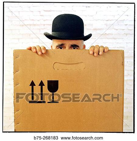 Man hiding inside a cardboard box View Large Photo Image Stock Image - Man hiding inside a cardboard box. Fotosearch