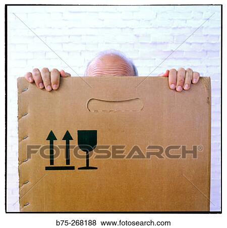 Man hiding inside a cardboard box View Large Photo Image Stock Photo - Man hiding inside a cardboard box. Fotosearch