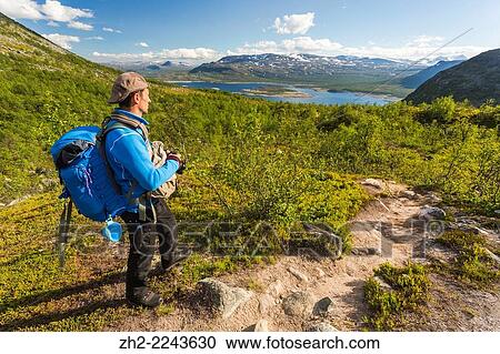Man hiking and watching view over stora sjofallets national park in G? llivare, Swedish lapland. View Large Photo Image Stock Image - Man hiking and watching view over stora sjofallets national park in G? llivare, Swedish lapland.. Fotosearch