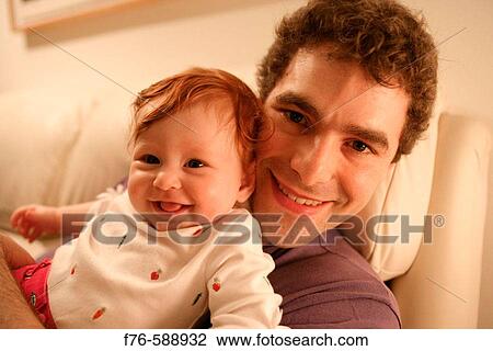 Man holding 6 month old baby girl View Large Photo Image Stock Image - Man holding 6 month old baby girl. Fotosearch