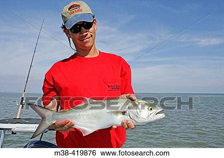 Man holding a Blue Fish in Islamorada, Florida. December 2004. View Large Photo Image Stock Photograph - Man holding a Blue Fish in Islamorada, Florida. December 2004.. Fotosearch