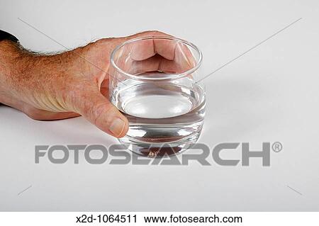 Man holding a glass of water Isolated Copy space View Large Photo Image Stock Image - Man holding a glass of water Isolated Copy space. Fotosearch