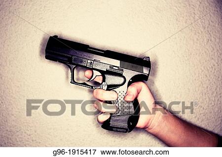 Man holding a gun View Large Photo Image Stock Photo - Man holding a gun. Fotosearch