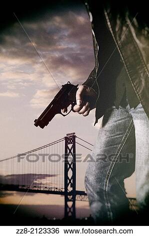 Stock Photograph - Man holding a gun.. Fotosearch