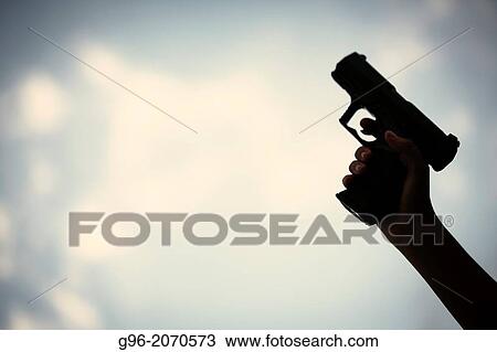 Man holding a pistol. View Large Photo Image Stock Image - Man holding a pistol.. Fotosearch