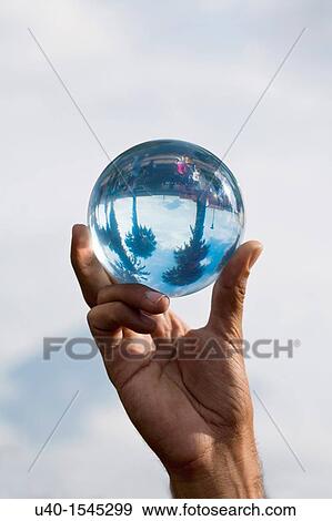 Man holding crystal ball View Large Photo Image Stock Photo - Man holding crystal ball. Fotosearch