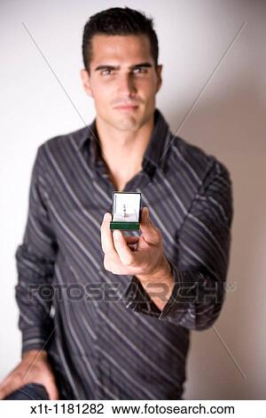 Man Holding Engagement Ring. View Large Photo Image Stock Image - Man Holding Engagement Ring.. Fotosearch