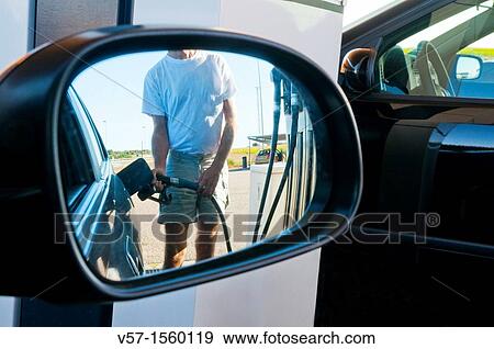 Man holding gas pistol, refuelling at a gas station View Large Photo Image Stock Photo - Man holding gas pistol, refuelling at a gas station. Fotosearch