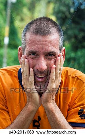 Stock Photo - Man holding his face.. Fotosearch