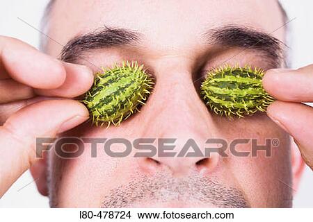 Man holding miniature pumpkin before his eyes View Large Photo Image Picture - Man holding miniature pumpkin before his eyes. Fotosearch