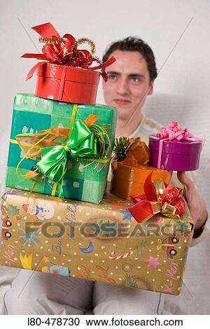 Stock Image - Man holding parcels. Fotosearch