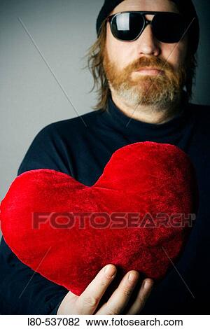 Man holding red heart pillow View Large Photo Image Stock Image - Man holding red heart pillow. Fotosearch