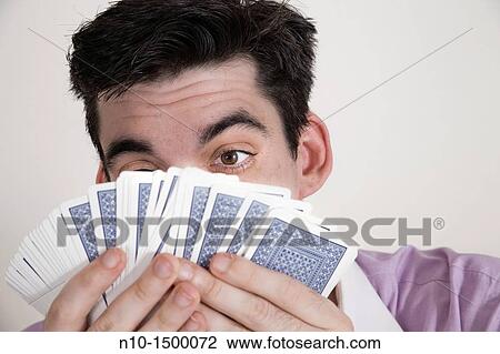 Man holding up a deck of playing cards View Large Photo Image Stock Image - Man holding up a deck of playing cards. Fotosearch