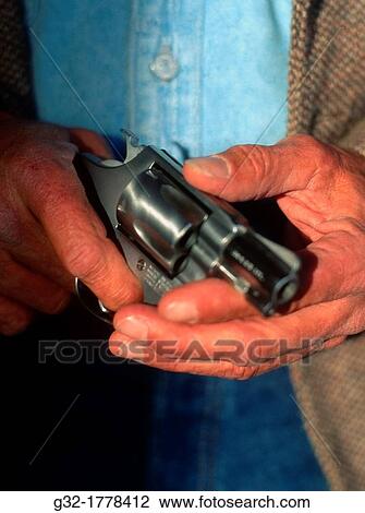 Man holds 38 pistol View Large Photo Image Stock Image - Man holds 38 pistol. Fotosearch