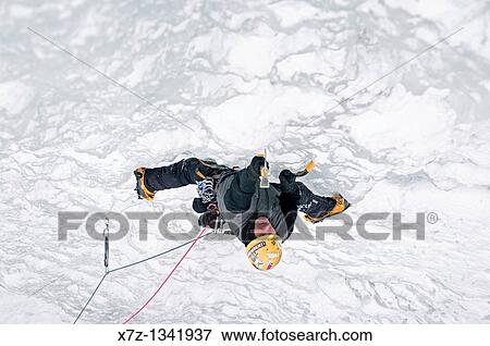 Stock Photo - Man ice climbing a route called Genesis which is rated WI, 5 and located in Hyalite Canyon near the city of Bozeman in western Montana. Fotosearch