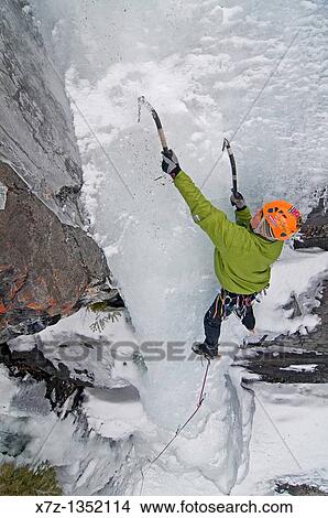 Man ice climbing a route called Nicotine Free which is rated WI4 and located near Rock Creek in the Elkhorn Mountains in eastern Oregon View Large Photo Image Picture - Man ice climbing a route called Nicotine Free which is rated WI4 and located near Rock Creek in the Elkhorn Mountains in eastern Oregon. Fotosearch