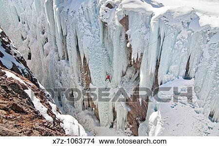 Man ice climbing a route called Root Canal which is rated WI5 at The Ouary Ice Park in the Uncompahgre River Gorge near the town of Ouray in southwestern Colorado USA View Large Photo Image Picture - Man ice climbing a route called Root Canal which is rated WI5 at The Ouary Ice Park in the Uncompahgre River Gorge near the town of Ouray in southwestern Colorado USA. Fotosearch