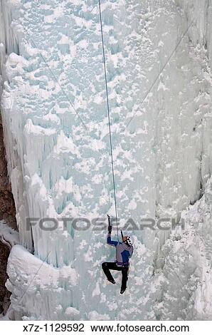 Stock Image - Man ice climbing a route called Root Canal which is rated WI-5 at The Ouary Ice Park in the Uncompahgre River Gorge near the town of Ouray in southwestern Colorado. Fotosearch