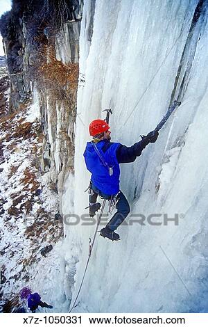Stock Image - Man ice climbing a route called Chrome-Moly which is rated WI4 at the Mother Lode Area in the Snake River Canyon near the city of Twin Falls Idaho USA. Fotosearch