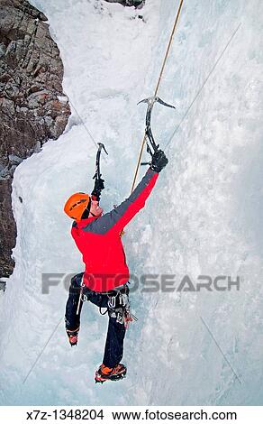 Picture - Man ice climbing a route which is rated WI4 near Silver Creek high in the Boulder Mountains in central Idaho. Fotosearch