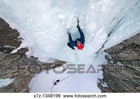 Stock Photo - Man ice climbing a route which is rated WI4 near Silver Creek high in the Boulder Mountains in central Idaho. Fotosearch