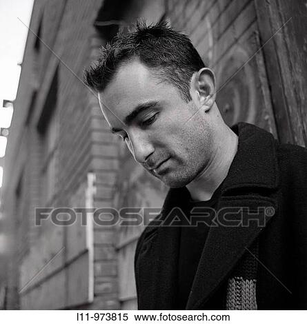 Man in alley, head bowed View Large Photo Image Stock Photography - Man in alley, head bowed. Fotosearch