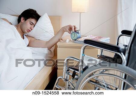 Man in bed and wheelchair View Large Photo Image Stock Photo - Man in bed and wheelchair. Fotosearch