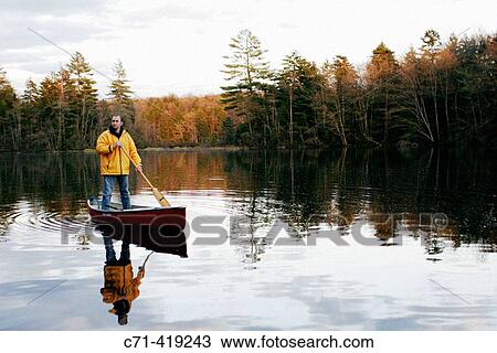 Man in canoe on mountain lake View Large Photo Image Stock Image - Man in canoe on mountain lake. Fotosearch