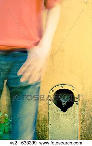 Stock Photo - Man in front of yellow bus. Fotosearch
