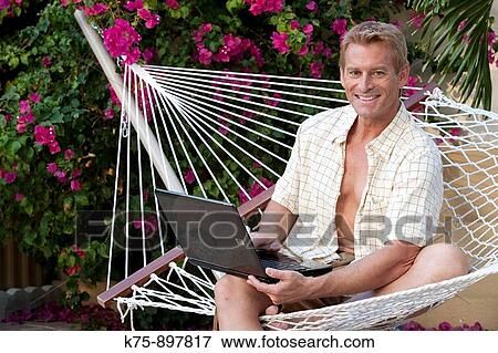 Man in hammock with laptop View Large Photo Image Stock Photo - Man in hammock with laptop. Fotosearch