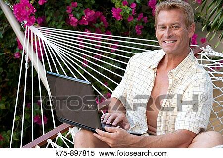 Man in hammock with laptop View Large Photo Image Stock Photography - Man in hammock with laptop. Fotosearch