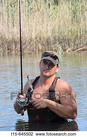 Man in his 30's fishing and looking disappointed staring at the bait with no fish View Large Photo Image Stock Image - Man in his 30's fishing and looking disappointed staring at the bait with no fish. Fotosearch