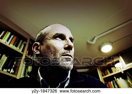 Stock Photograph - Man in library. Fotosearch