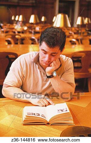 Stock Photograph - Man in library. Fotosearch