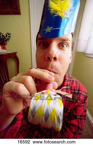 Man in pajamas with party hat and party blower View Large Photo Image Stock Image - Man in pajamas with party hat and party blower. Fotosearch