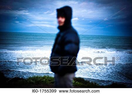 Stock Photo - Man in Playa de las Catedrales, Lugo province, Galicia, Spain. Fotosearch