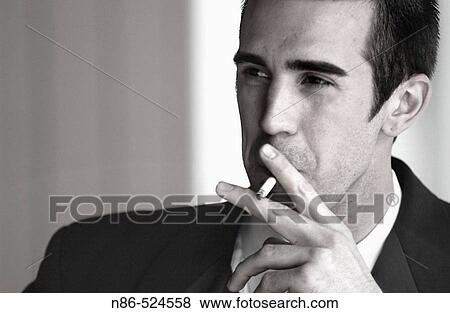 Man in suit smoking View Large Photo Image Stock Photo - Man in suit smoking. Fotosearch