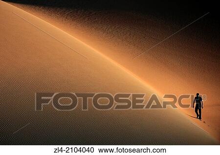 Man in the sand dunes of the empty quarter desert. United Arab Emirates, UAE, Abu Dhabi, Liwa Oasis, Moreeb Hill, Tal Mireb. Model Released. View Large Photo Image Stock Image - Man in the sand dunes of the empty quarter desert. United Arab Emirates, UAE, Abu Dhabi, Liwa Oasis, Moreeb Hill, Tal Mireb. Model Released.. Fotosearch